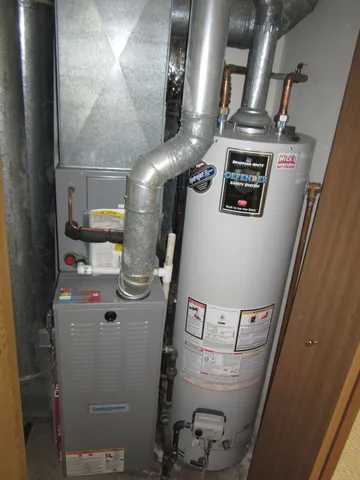 a view of water heater room with washer and dryer