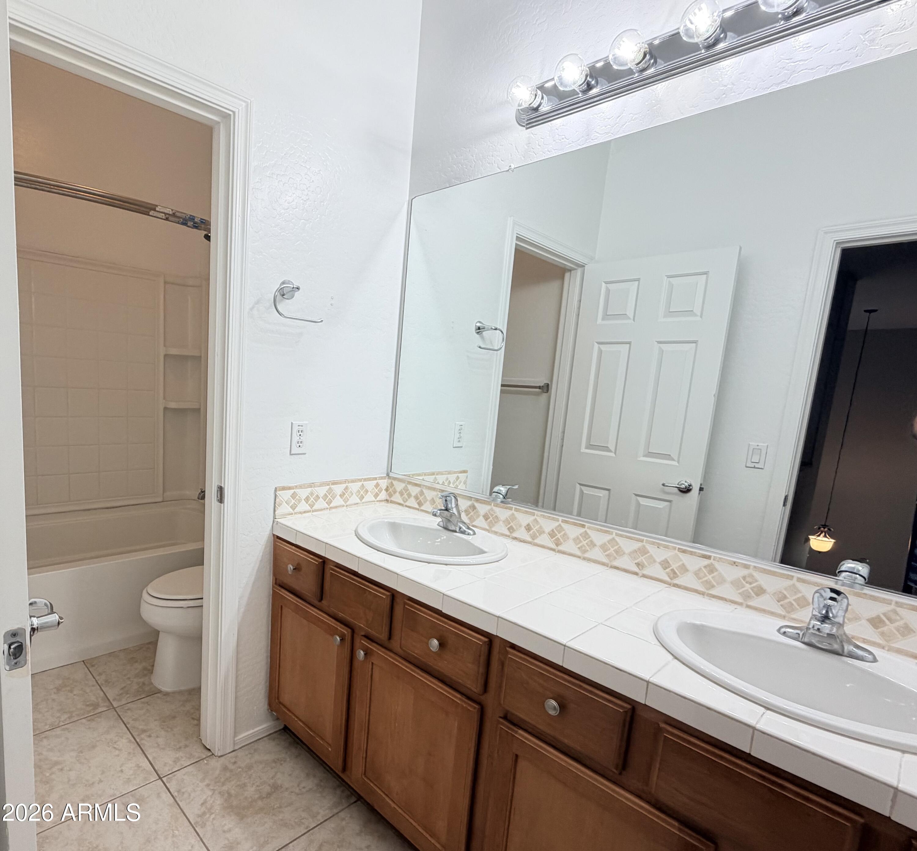 191 West Rio Drive Casa Grande, AZ 85122 - Photo 22 of 34 a bathroom with a double vanity sink toilet and mirror