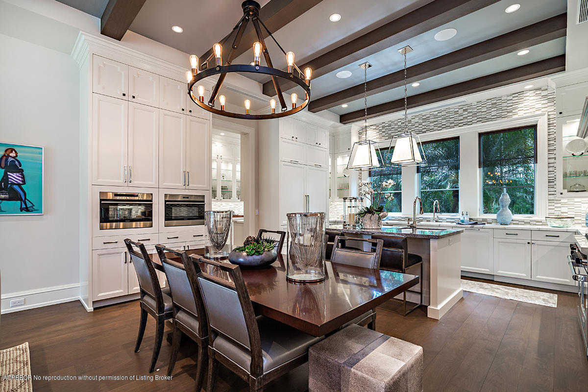 8 Golfview Road Palm Beach, FL 33480 - Photo 24 of 61 a dining room with wooden floor a chandelier a wooden table and chairs