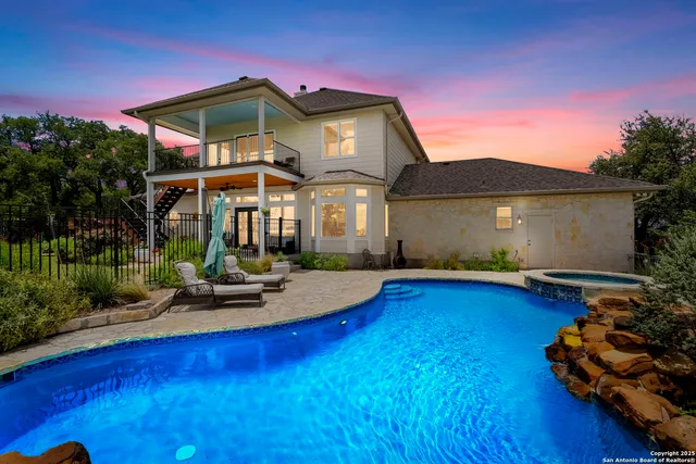 a front view of a house with swimming pool having outdoor seating