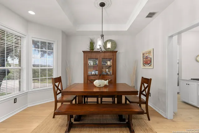 a view of a dining room with furniture window and wooden floor