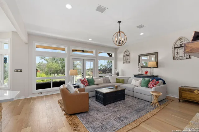 a living room with patio furniture and a large window