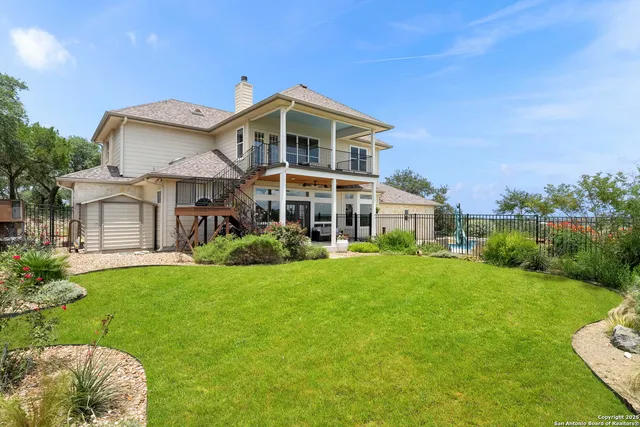 a front view of a house with a yard table and chairs