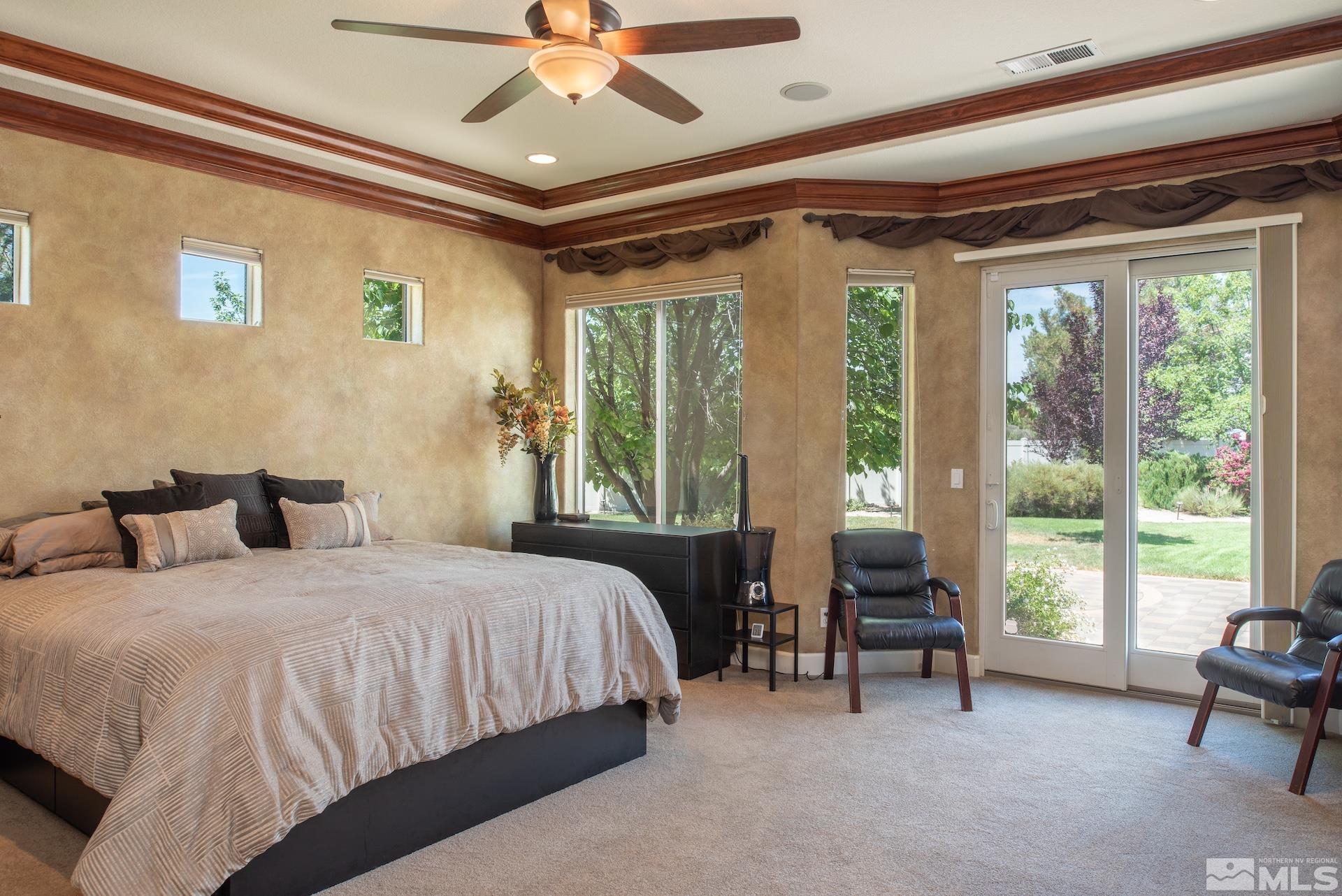 2635 Vitoria Lane Reno, NV 89521 - Photo 13 of 40 a bedroom with a bed and a chandelier