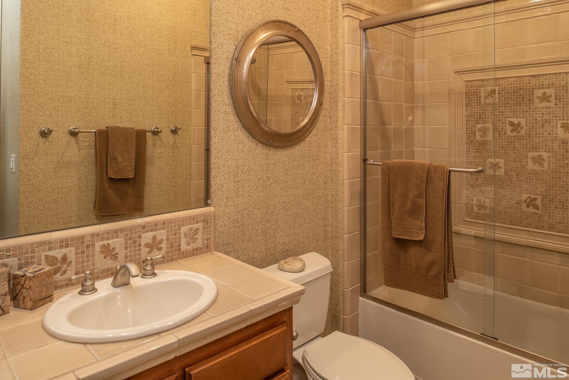 2635 Vitoria Lane Reno, NV 89521 - Photo 19 of 40 a bathroom with a sink a toilet and shower