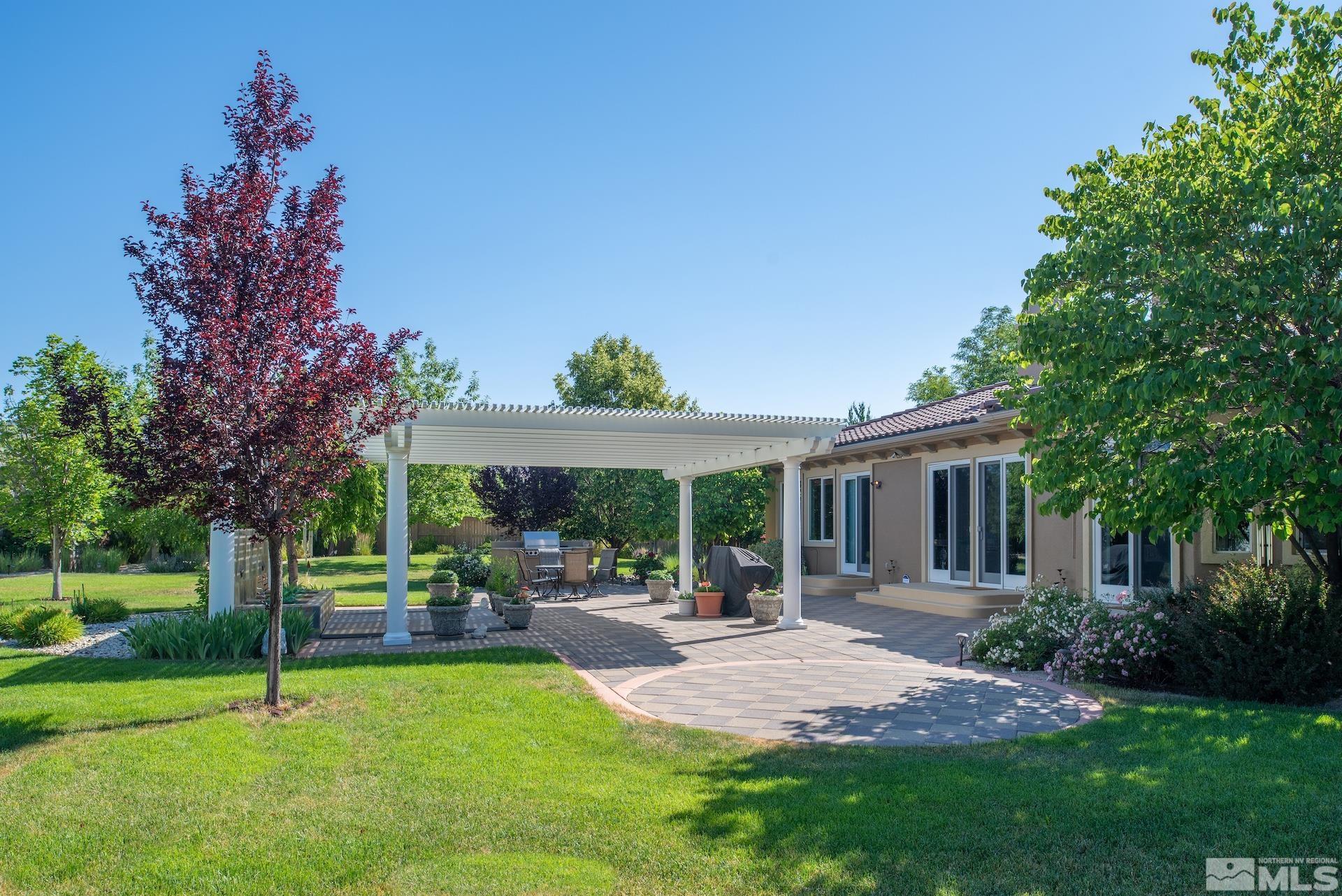 2635 Vitoria Lane Reno, NV 89521 - Photo 24 of 40 a view of a house with a backyard and a patio