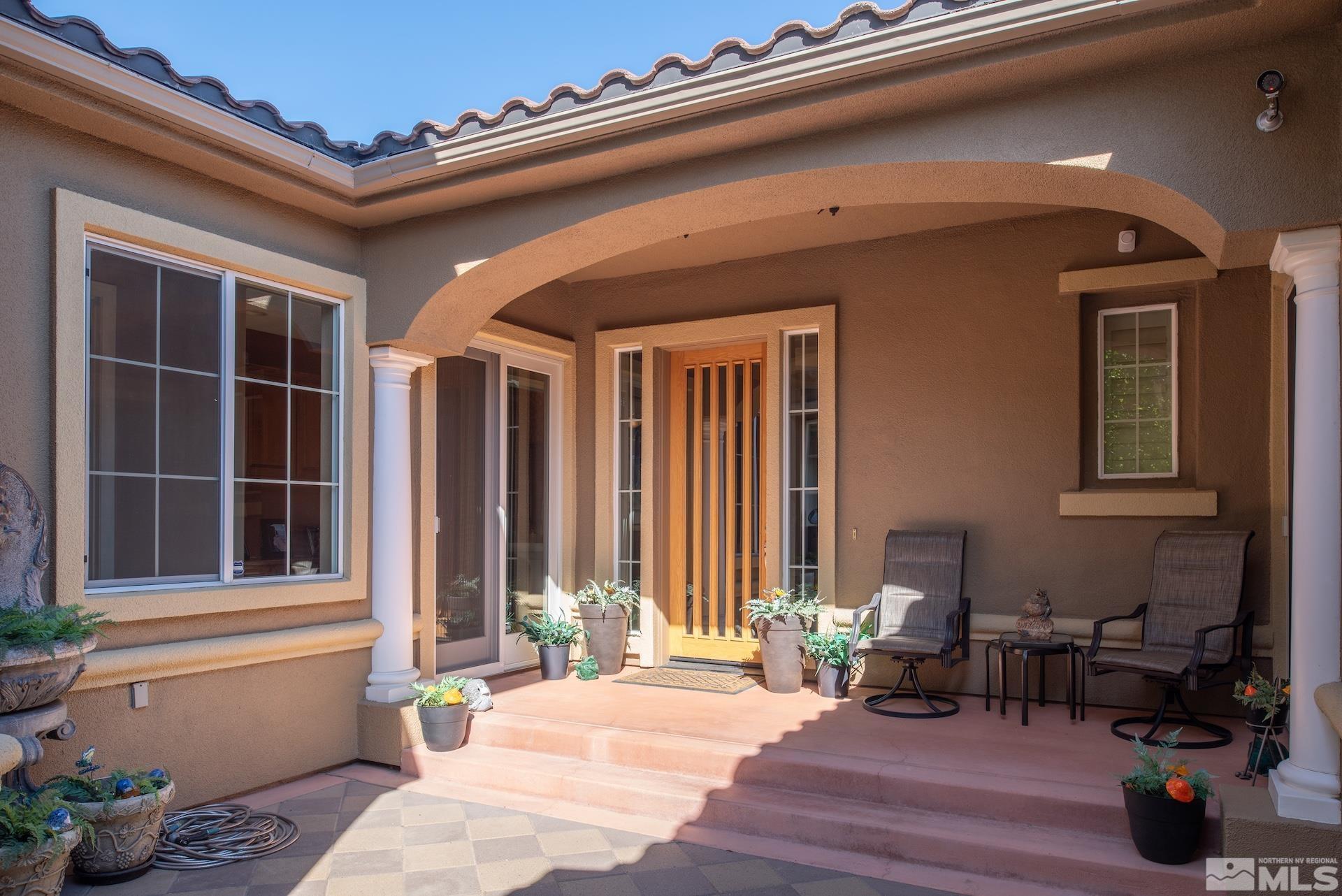 2635 Vitoria Lane Reno, NV 89521 - Photo 3 of 40 a view of a patio with table and chairs and potted plants