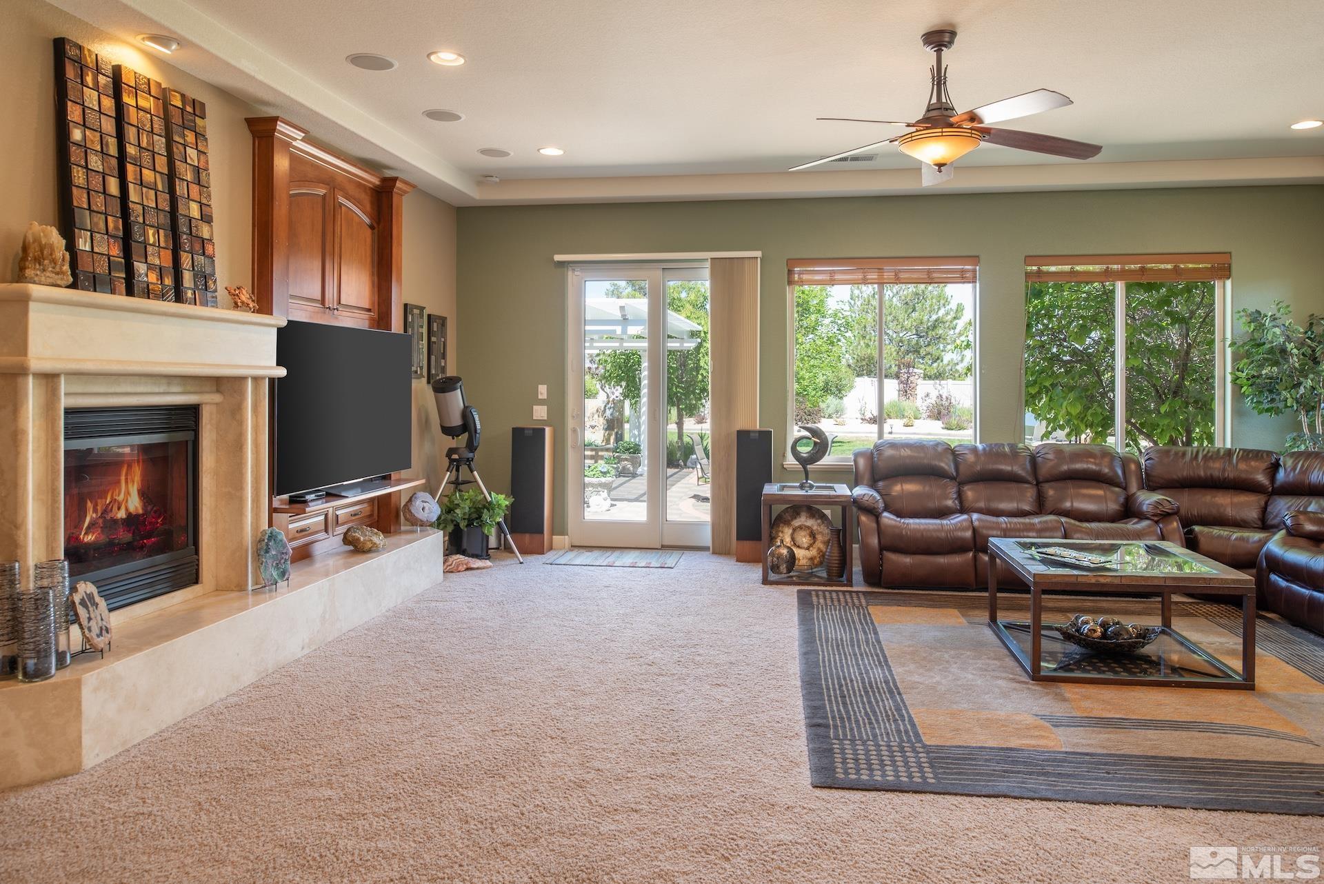2635 Vitoria Lane Reno, NV 89521 - Photo 5 of 40 a living room with furniture large window and flat screen tv