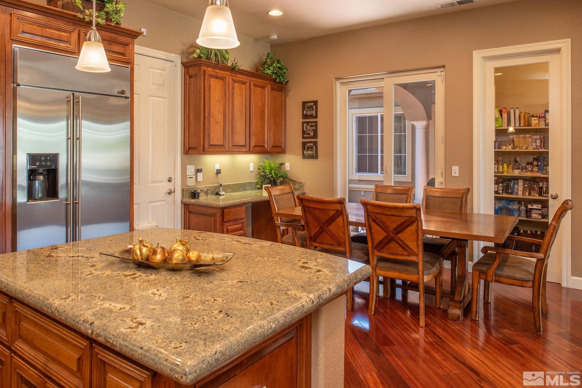 2635 Vitoria Lane Reno, NV 89521 - Photo 9 of 40 a view of a dining room with furniture window and wooden floor