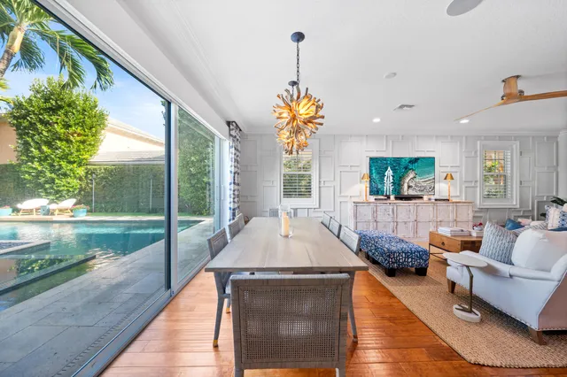 a living room with fireplace furniture and a large window