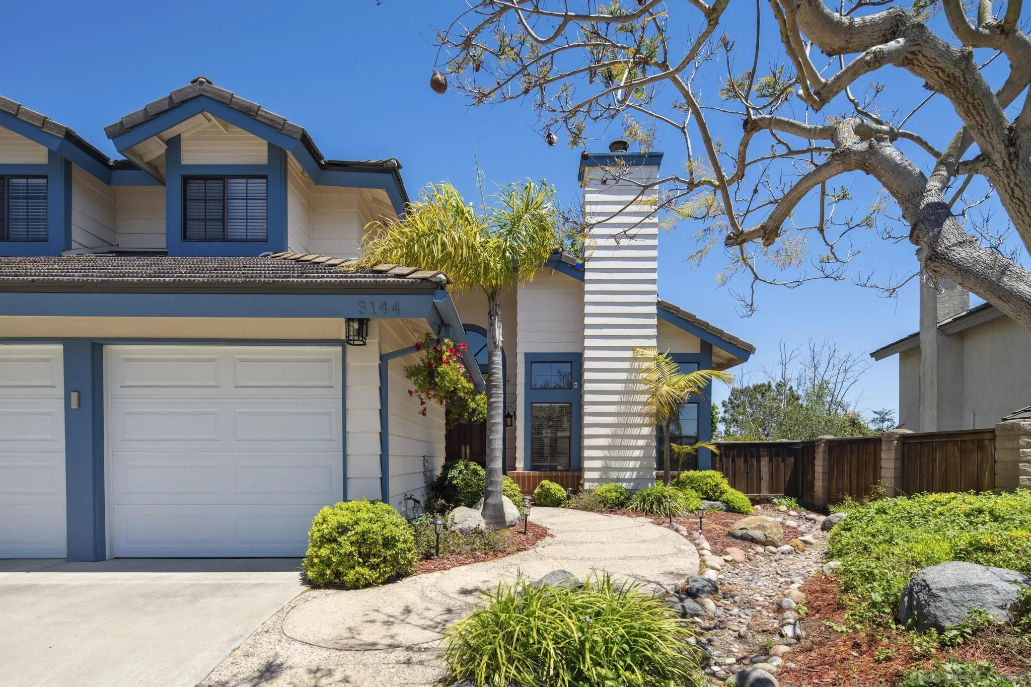 3144 Lower Ridge Road San Diego, CA 92130 - Photo 36 of 55 a front view of a house with garden