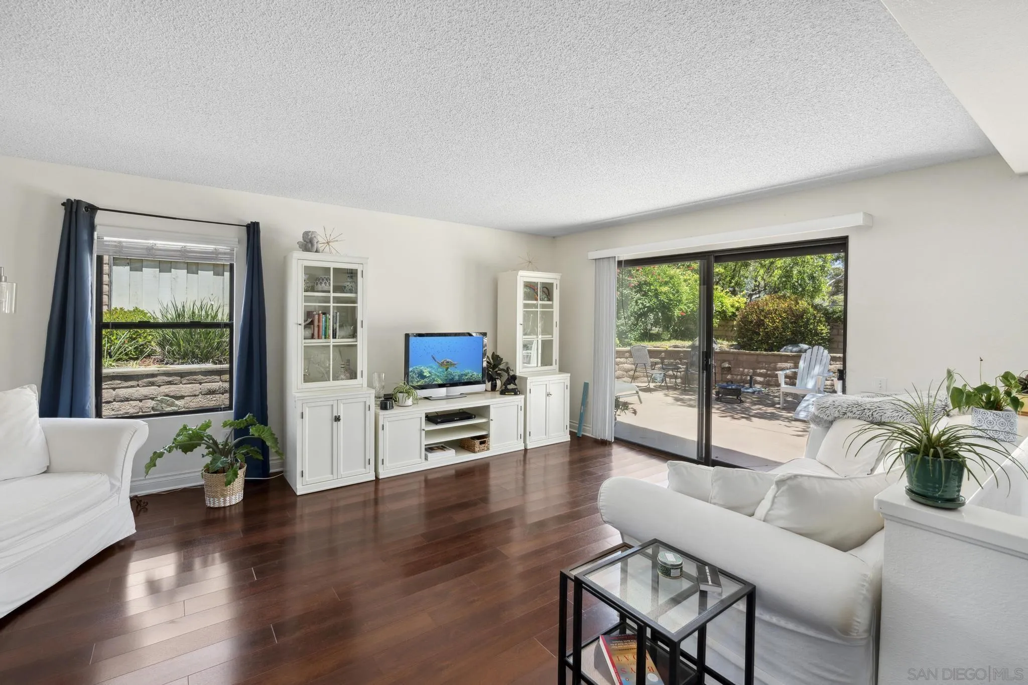 3144 Lower Ridge Road San Diego, CA 92130 - Photo 8 of 55 a living room with furniture flat screen tv and a large window