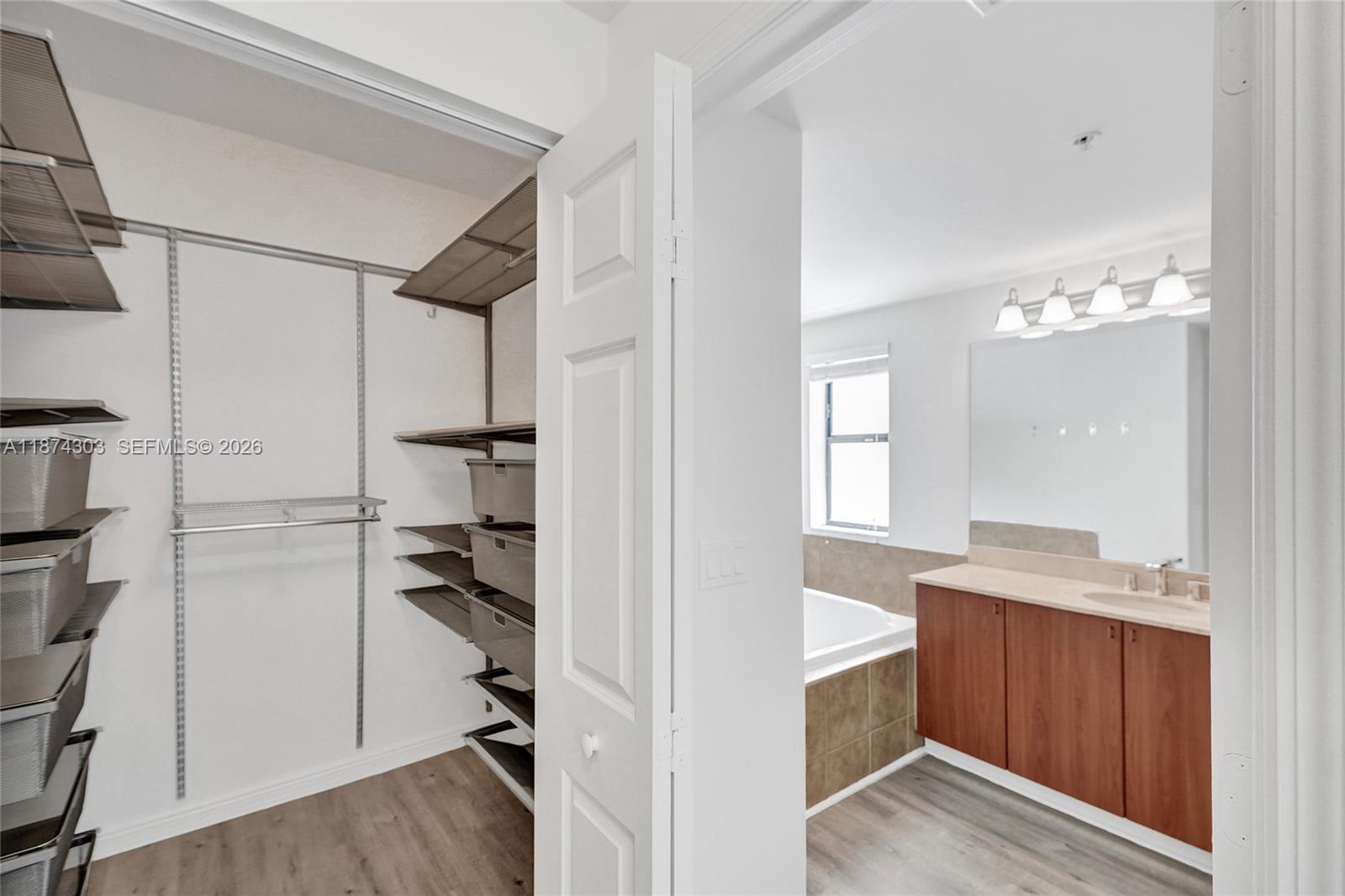 888 Douglas Road, Unit 304 Coral Gables, FL 33134 - Photo 28 of 52 a view of a kitchen with a sink and wooden floor