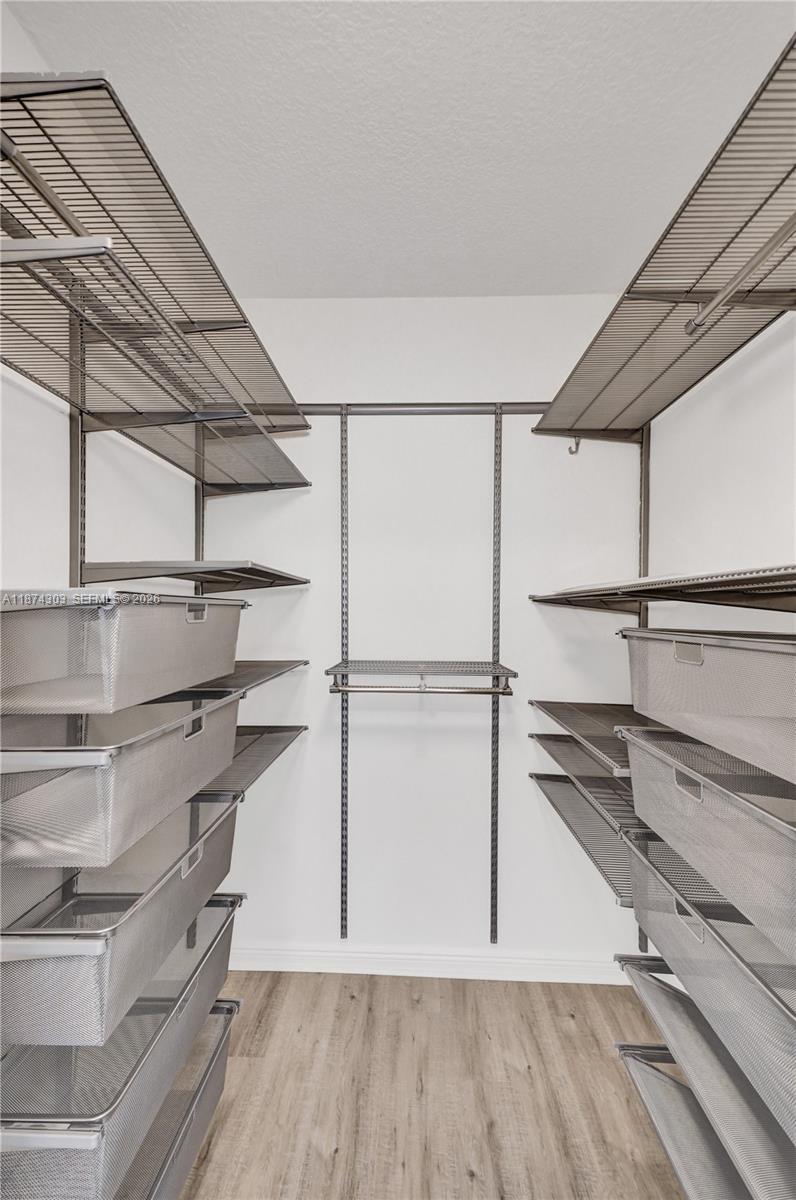 888 Douglas Road, Unit 304 Coral Gables, FL 33134 - Photo 30 of 52 a view of walk in closet with empty racks