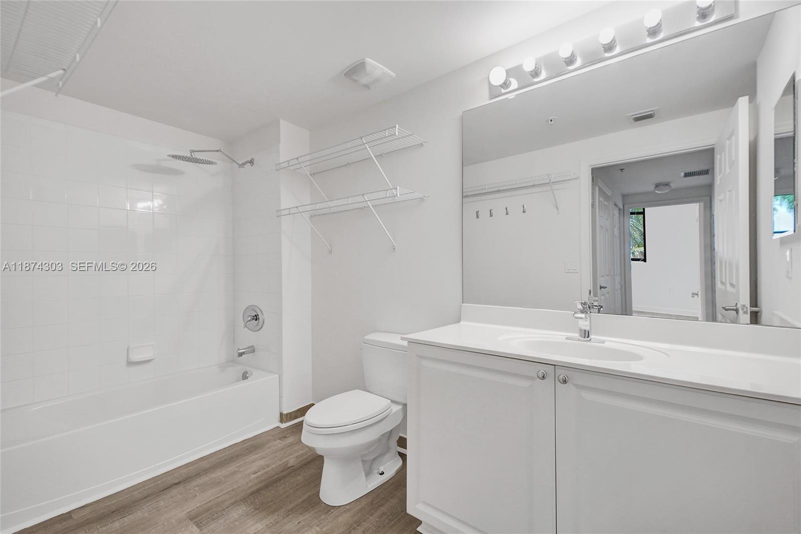 888 Douglas Road, Unit 304 Coral Gables, FL 33134 - Photo 31 of 52 a bathroom with a sink a toilet and shower