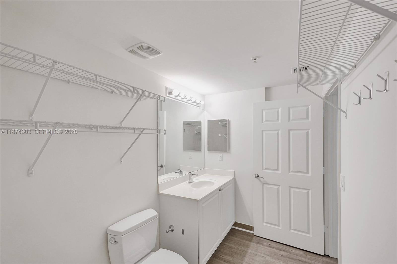 888 Douglas Road, Unit 304 Coral Gables, FL 33134 - Photo 32 of 52 a bathroom with a sink a toilet and shower