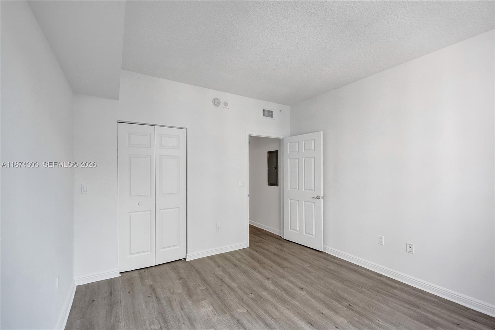 888 Douglas Road, Unit 304 Coral Gables, FL 33134 - Photo 38 of 52 a view of an empty room and wooden floor