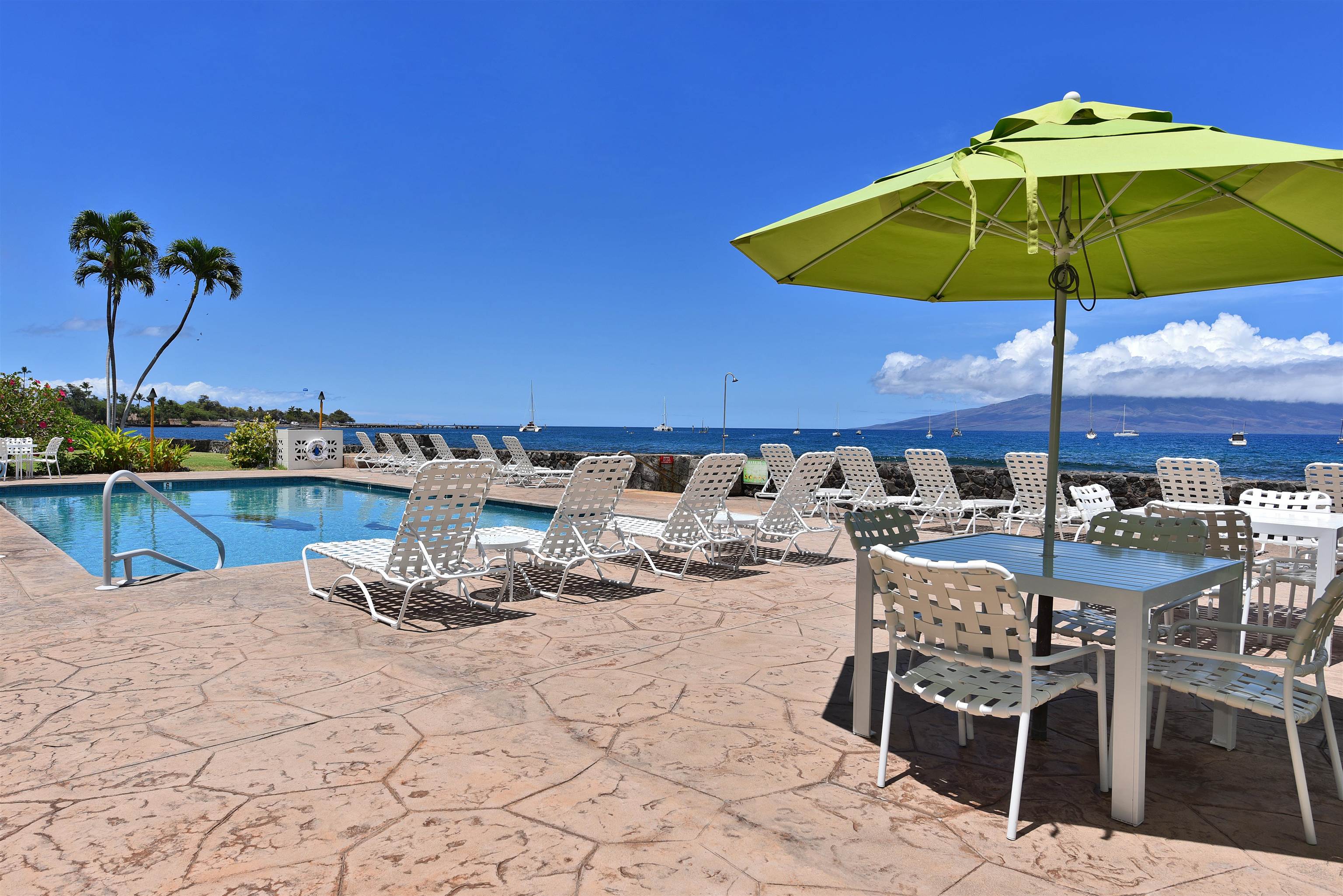 1403 Front Street, Unit 308 Lahaina, HI 96761 - Photo 28 of 35 a view of a swimming pool with chairs in patio