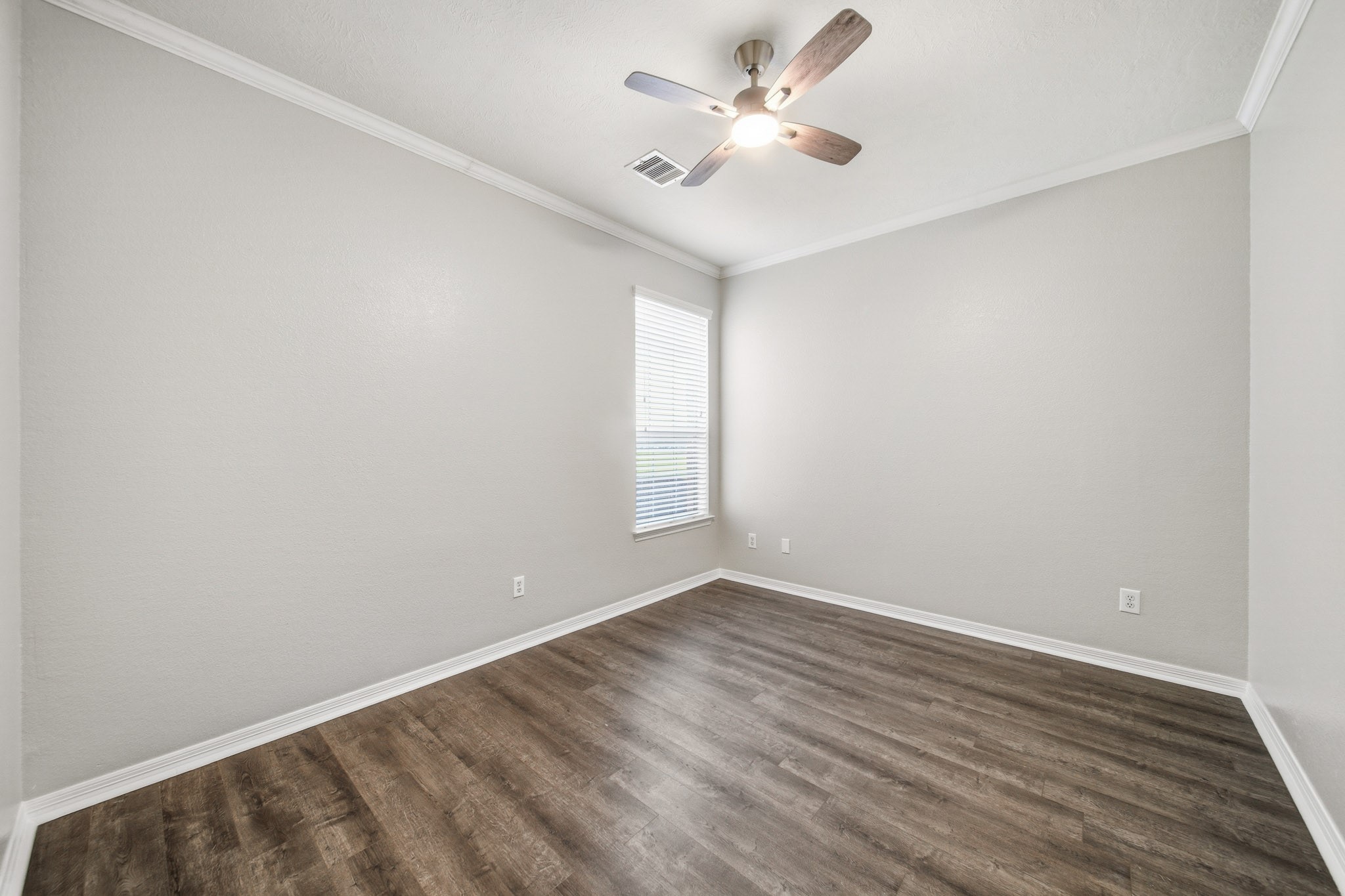 2711 Wallingford Pines Houston, TX 77042 - Photo 5 of 8 an empty room with wooden floor and windows