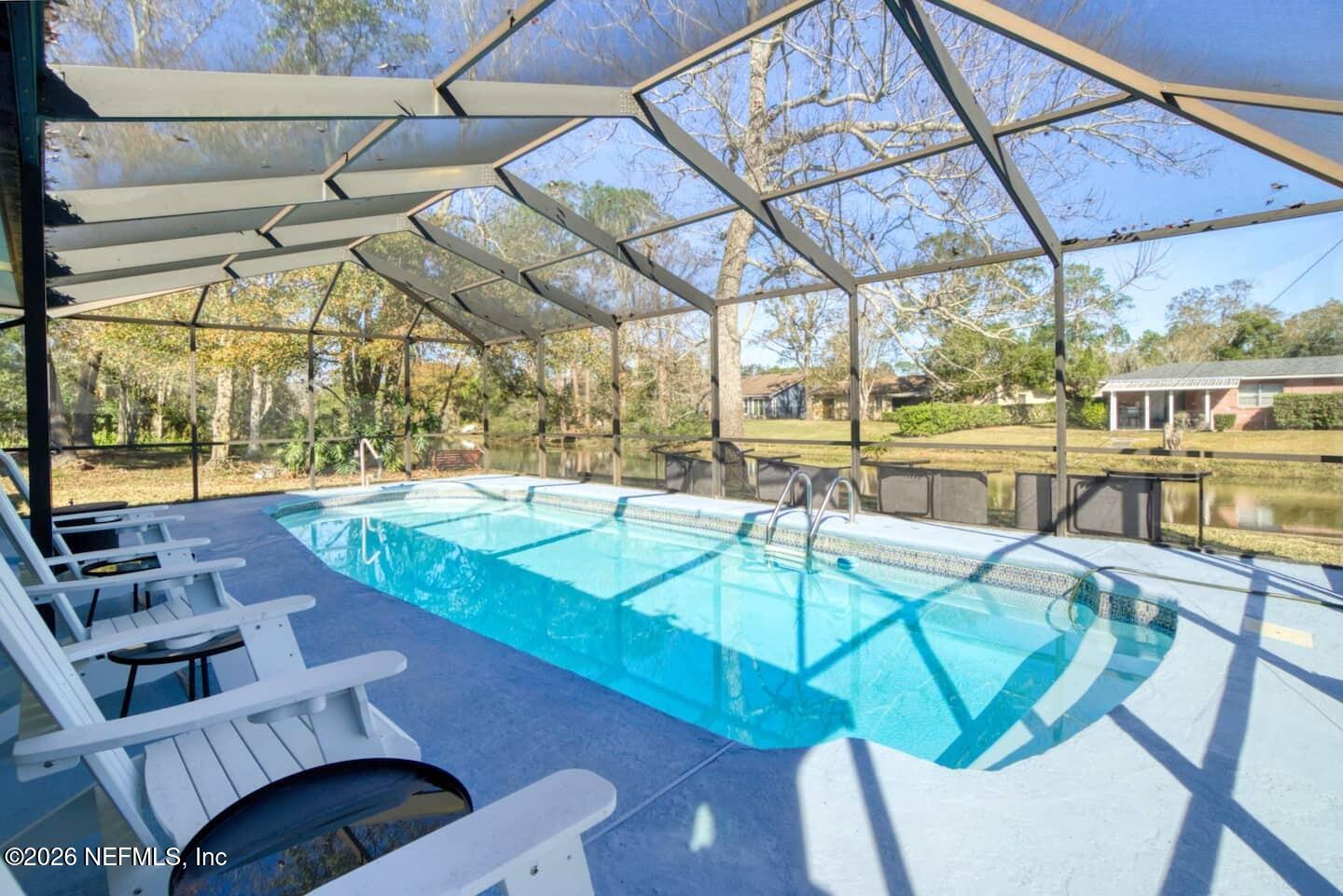 11613 Lake Ride Drive Jacksonville, FL 32223 - Photo 6 of 42 a view of a swimming pool with a patio