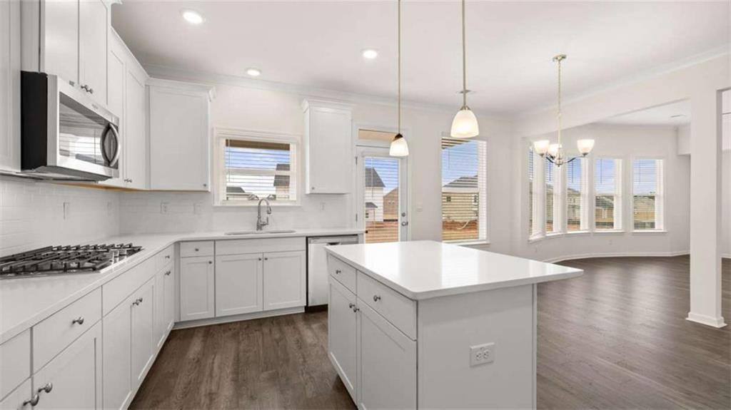 1791 Goodwin Drive Hampton, GA 30228 - Photo 13 of 43 a kitchen with stainless steel appliances granite countertop a sink stove and microwave