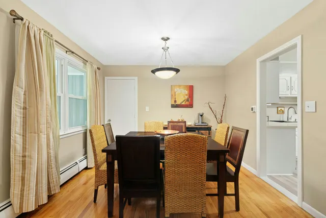 a view of a dining room with furniture window and wooden floor