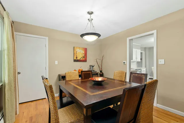 a view of a dining room with a table and chairs
