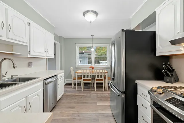 a kitchen with a stove a refrigerator and a sink