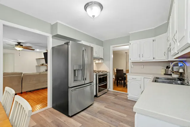a kitchen with stainless steel appliances granite countertop a refrigerator and a stove top oven