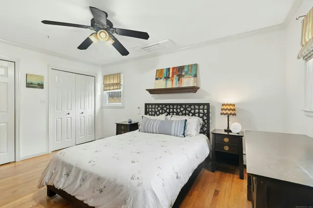 a bed room with a bed and a painting on the wall