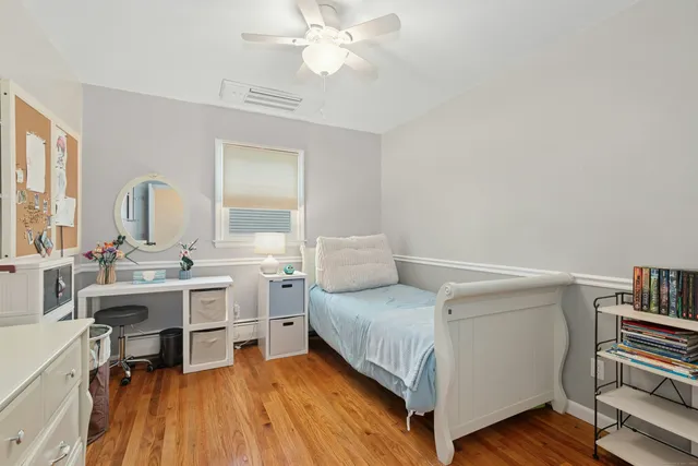 a view of a bedroom with furniture and a chandelier