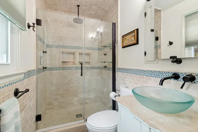 a bathroom with a sink toilet and shower