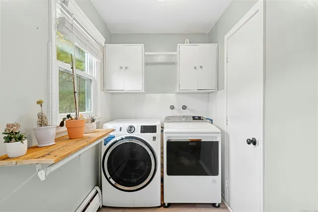 a utility room with sink dryer and washer