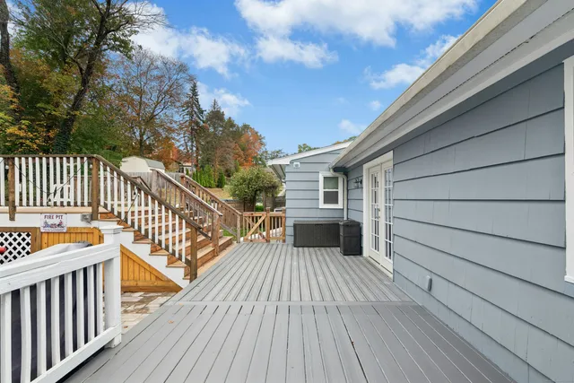 a balcony with wooden floor and fence