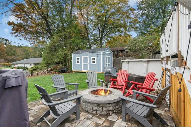 a backyard of a house with outdoor seating