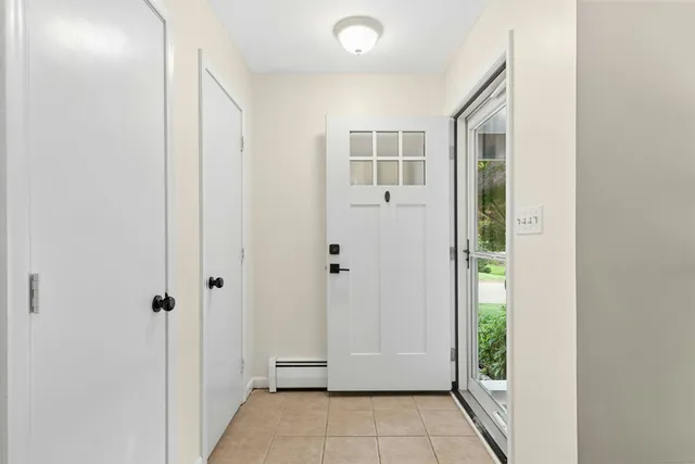 a view of a hallway with wooden floor and entryway