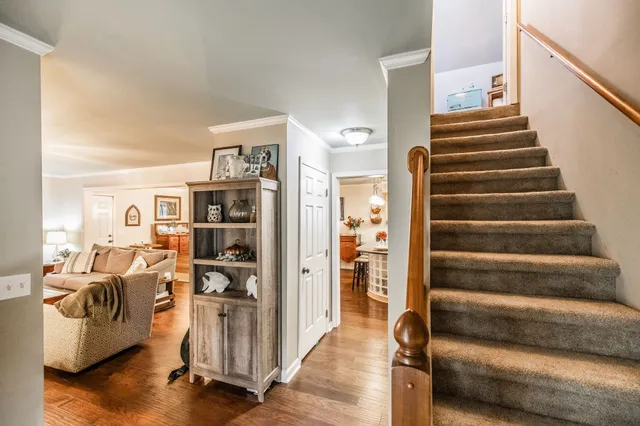 a view of a livingroom with furniture and stairs