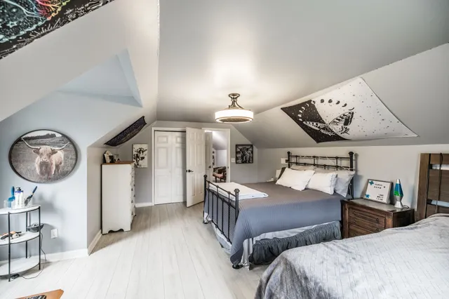 a bedroom with two beds and a chandelier