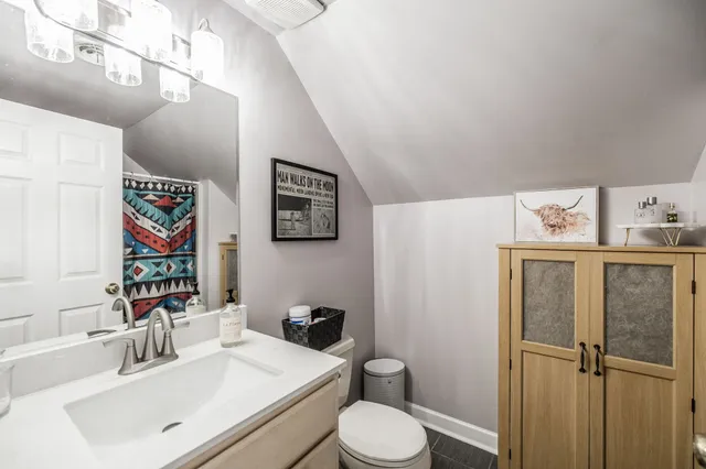 a bathroom with a sink toilet and mirror