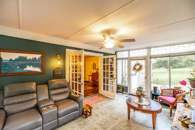 a living room with furniture and a floor to ceiling window