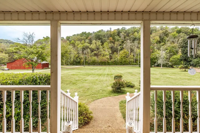 a front view of a house with garden and seating area