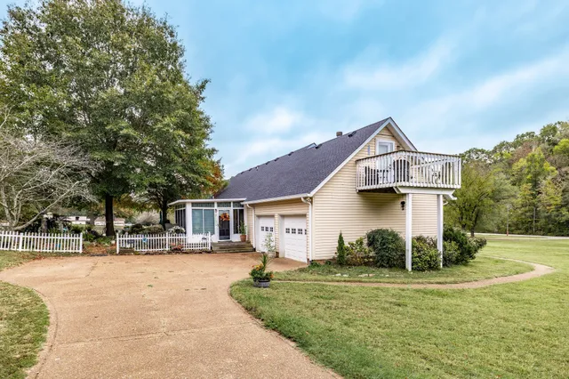 a view of a field with trees in the background