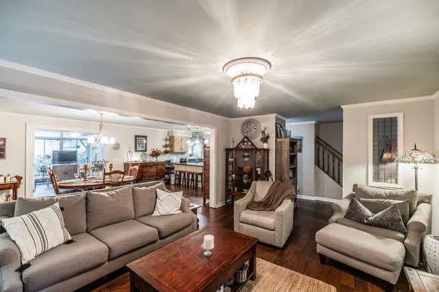 a living room with furniture and a chandelier