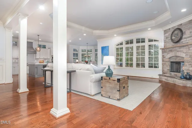 a living room with fireplace furniture and a wooden floor