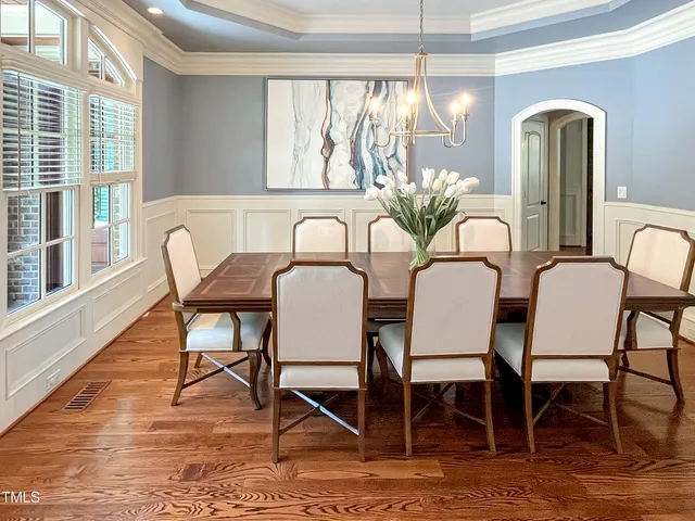 a view of a dining room with furniture wooden floor and a chandelier