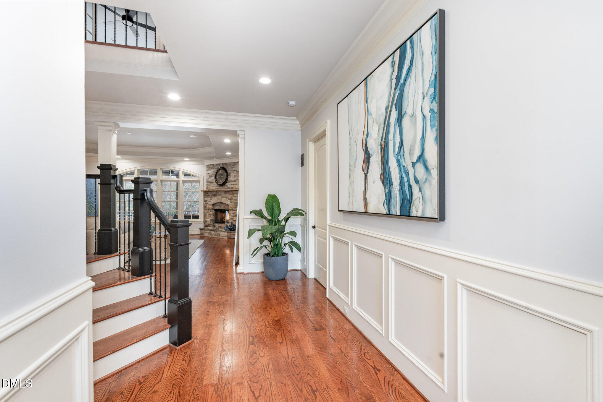 2908 Claremont Road Raleigh, NC 27608 - Photo 17 of 46 a hallway with wooden floor and a potted plant