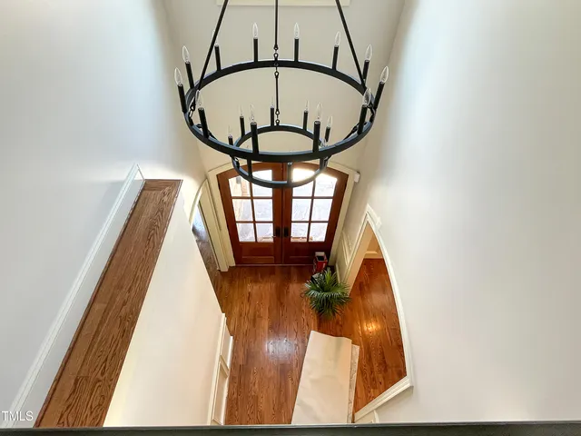 a view of staircase with railing and frames on wall