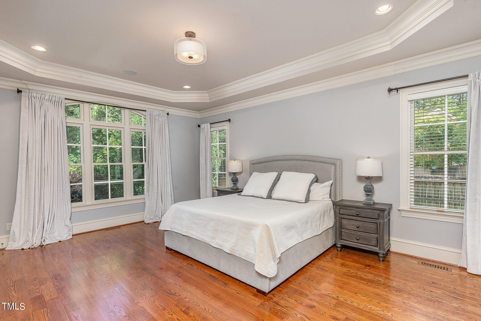 2908 Claremont Road Raleigh, NC 27608 - Photo 21 of 46 a bedroom with a large bed and a large window