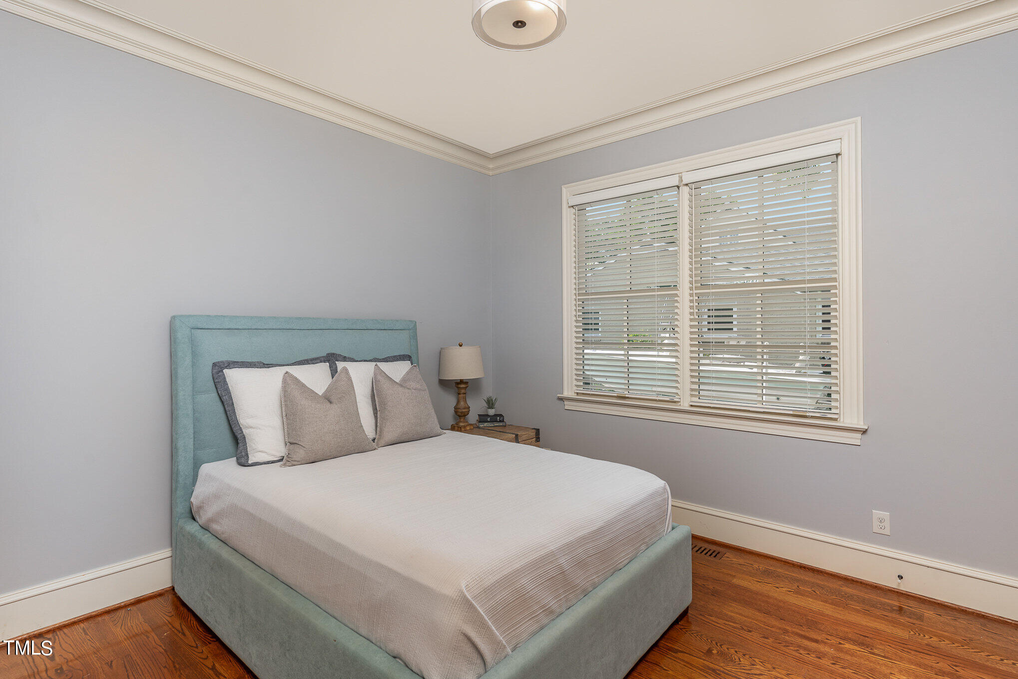 2908 Claremont Road Raleigh, NC 27608 - Photo 24 of 46 a large bed sitting in a bedroom next to a window