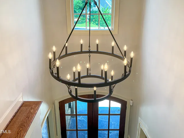 a view of staircase with wooden floor and a large window